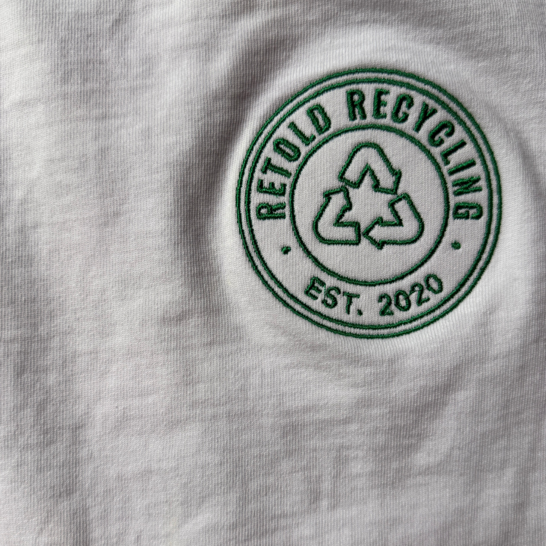 The Retold Emblem Tee