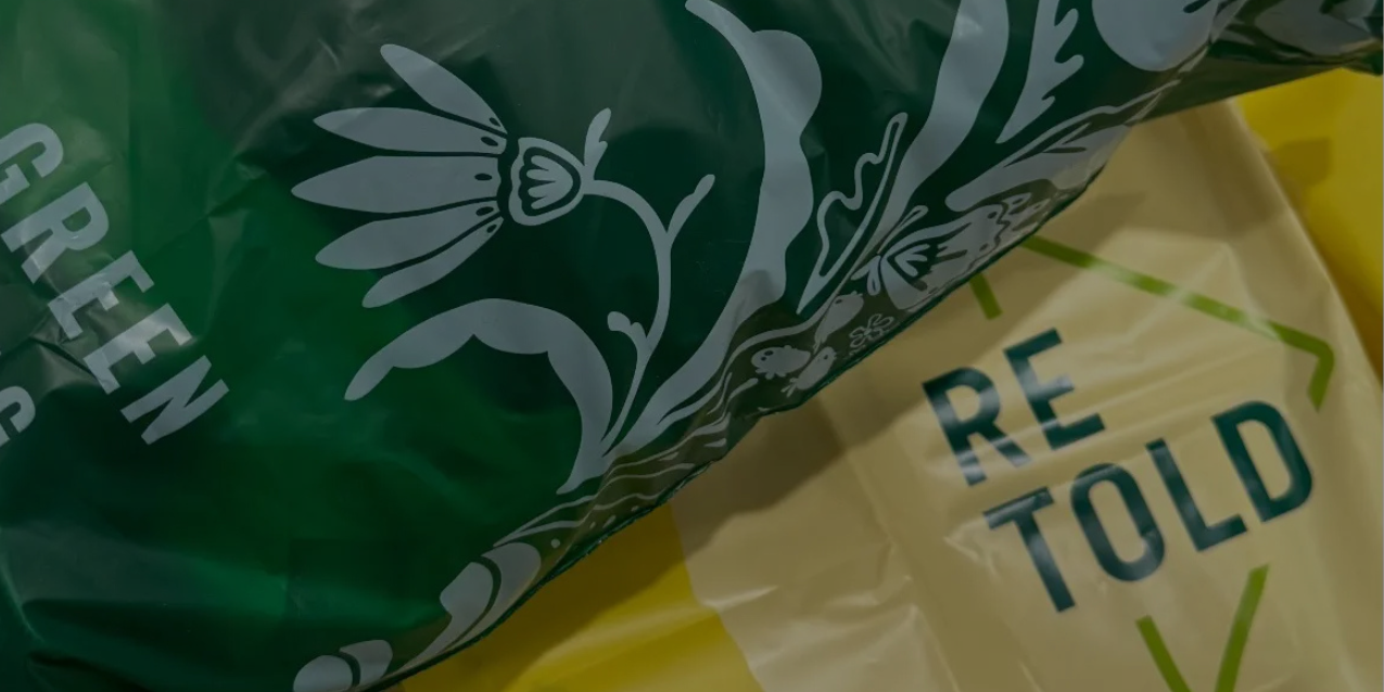 Close-up of a green and yellow bags with floral design and text.