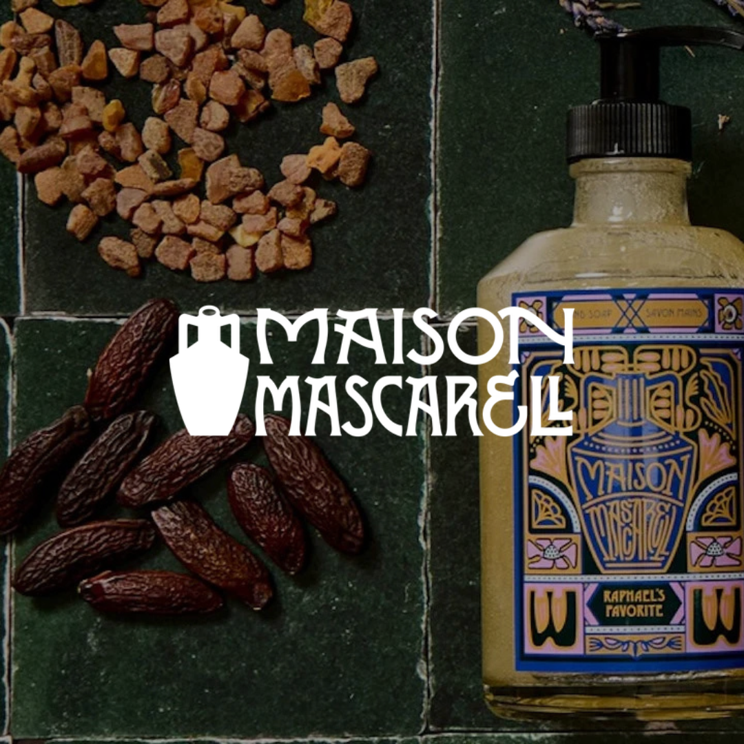 Bottle of Maison Mascarell with ingredients on a dark surface