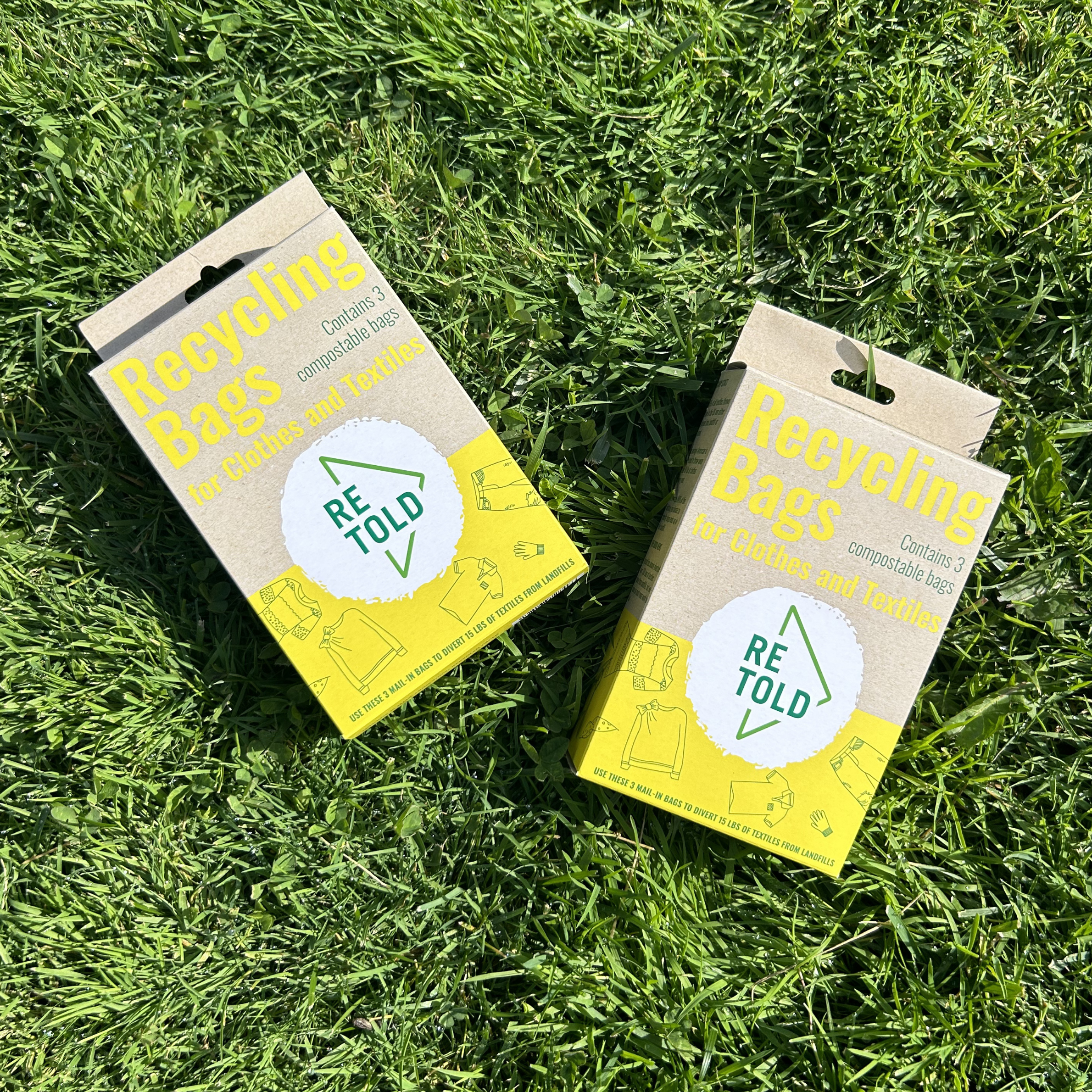 Two packages of 'Recycling Bags' by 'RETOLD' on a grass background